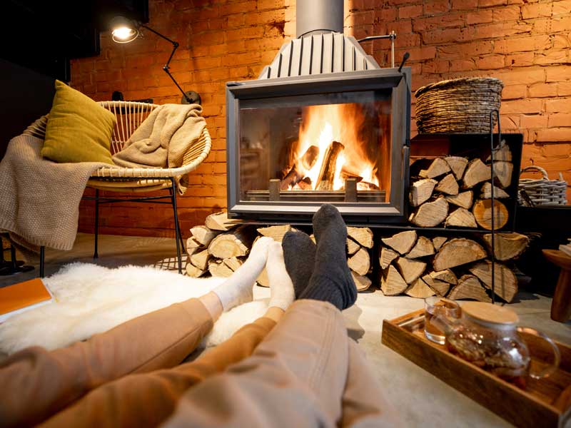 couple-lying-by-burning-fireplace-cozy-house-loft-style